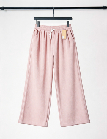 Pink pants on a hanger with a white background