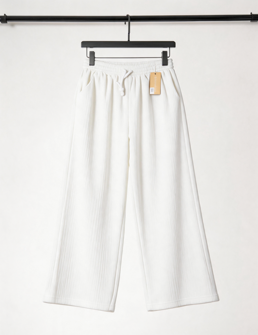 White pants on a hanger against a white background