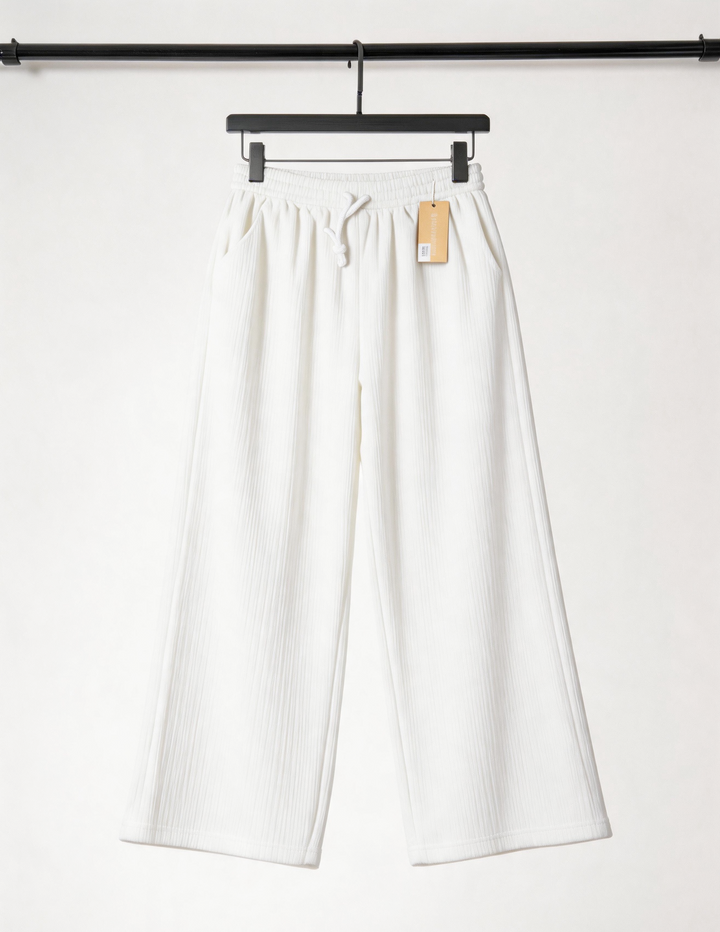 White pants on a hanger against a white background