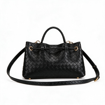 Black woven leather handbag with a top handle, adjustable shoulder strap, and gold-tone hardware, photographed on a clean white background.
