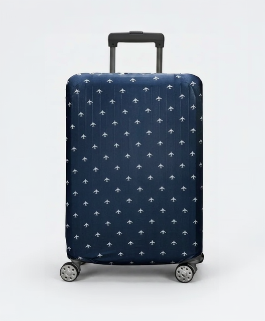 Navy blue suitcase with white airplane pattern on a light gray background