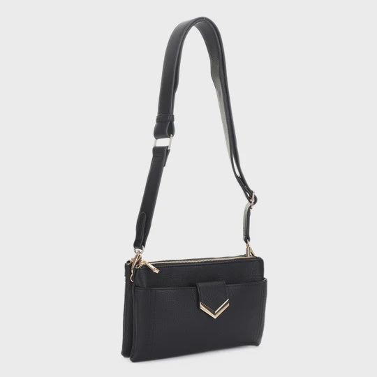 A black leather crossbody handbag with a long shoulder strap, front zippered pocket, and gold-tone chevron hardware, shown against a light gray background.