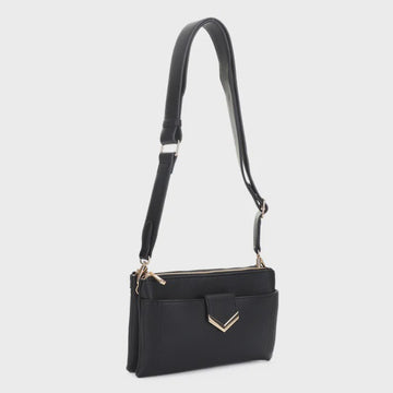 A black leather crossbody handbag with a long shoulder strap, front zippered pocket, and gold-tone chevron hardware, shown against a light gray background.