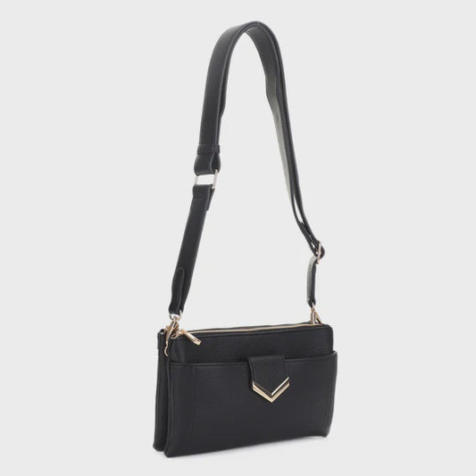 A black leather crossbody handbag with a long shoulder strap, front zippered pocket, and gold-tone chevron hardware, shown against a light gray background.