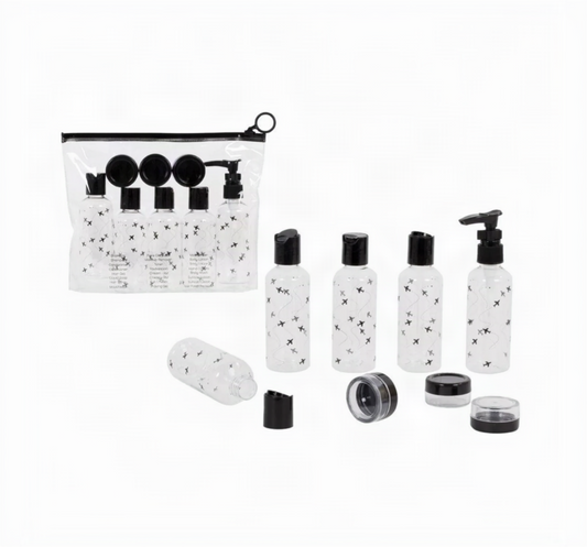 9-piece travel bottle set with clear airplane-print bottles, a pump bottle, three jars with black lids, and a clear zip pouch
