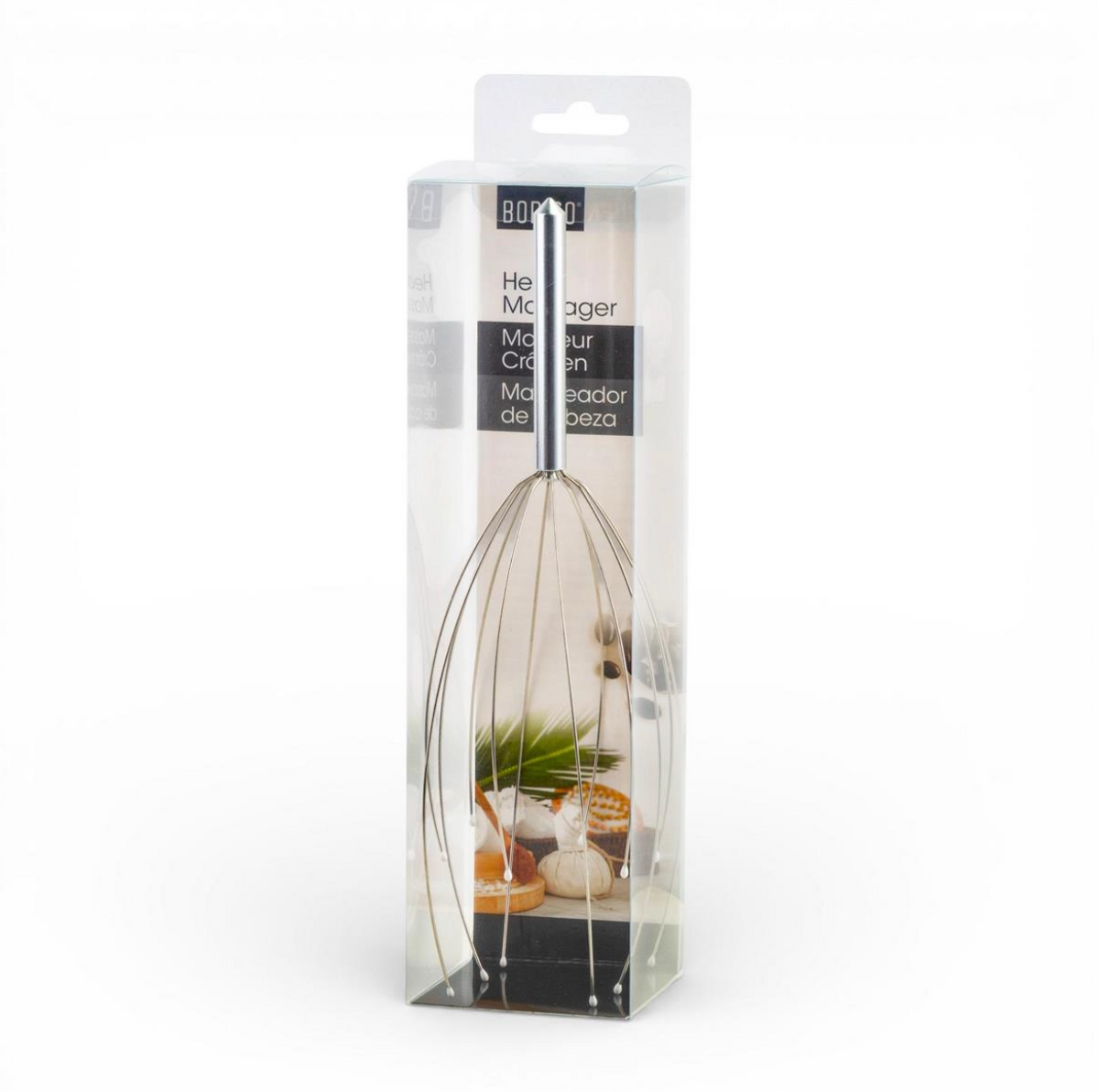A packaged electric hand mixer with wire beaters, shown inside a clear plastic retail box with a white header card. The box has Spanish text and a small kitchen-themed graphic near the bottom.