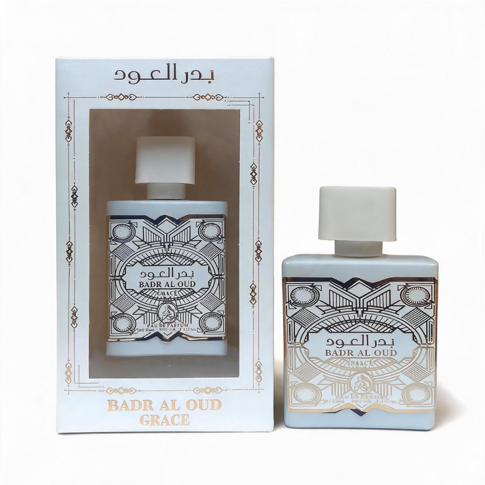 Oud Al Badr Grace Eau de Parfum bottle in ivory and gold with ornate detailing, next to its matching packaging box, displayed against a white background.