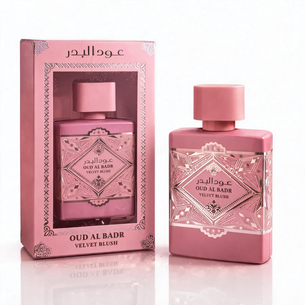 Oud Al Badr Velvet Blush Eau de Parfum bottle in blush pink with ornate engraved detailing, next to its matching packaging box, displayed against a white background.